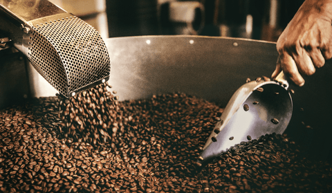 Image of a coffee beans in a coffee roaster being turned by hand